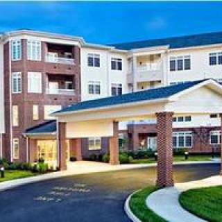A modern residential apartment building with a covered entrance.