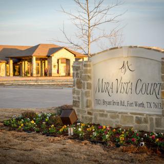 Entrance sign and building of Maya Vista Courtyards in Fort Worth, Texas.