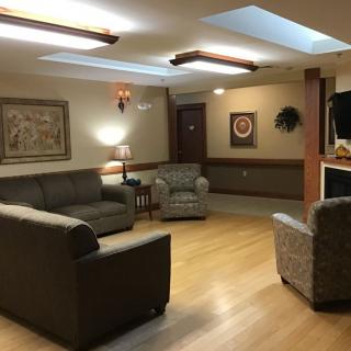 A cozy living room with comfortable seating and warm lighting.