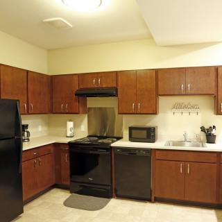 A modern kitchen with wooden cabinets and various appliances.