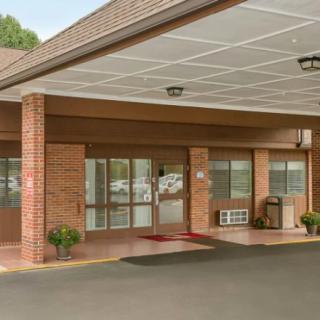 A building entrance with a covered awning and brick exterior.