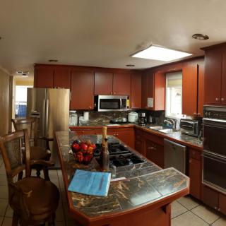 A modern kitchen with wooden cabinets and an array of appliances.