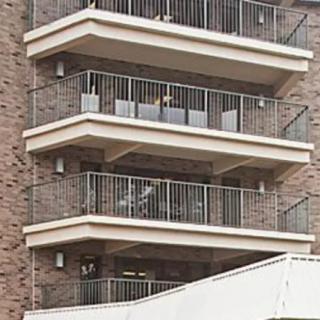 A close-up view of an apartment building with multiple balconies.