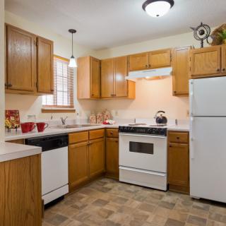 A cozy kitchen with wooden cabinets and modern appliances.