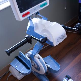 A stationary exercise bike designed for fitness and rehabilitation purposes.