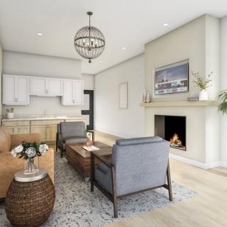 A modern and cozy living room with an open kitchen, featuring a warm fireplace and stylish furniture.