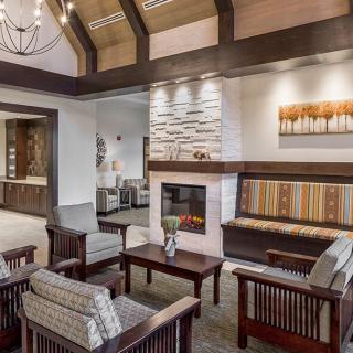 A cozy living room with modern wooden furniture and a fireplace.