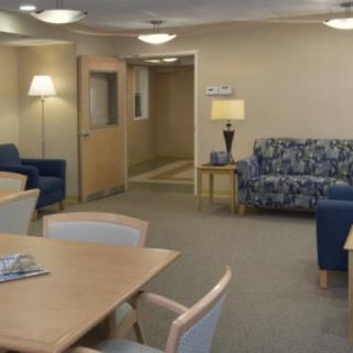 A comfortable office waiting area with seating and a table.