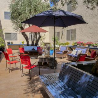 A welcoming outdoor patio with seating, umbrellas, and tables.
