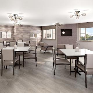 A modern dining area featuring several tables and chairs arranged in a spacious setting.