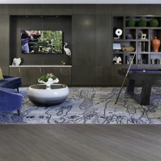 A modern living room with a pool table and stylish furnishings.
