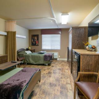 A spacious and comfortable hospital patient room designed for recovery.