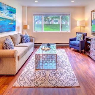 A cozy and modern living room featuring a comfortable sofa, decorative rug, and a stylish coffee table.
