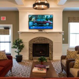 A cozy living room with a fireplace, television, and comfortable seating.