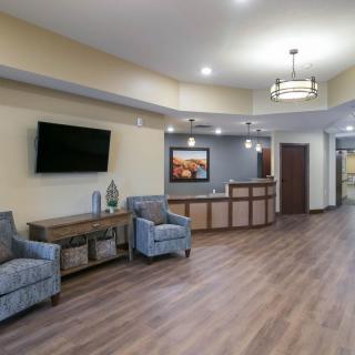 A stylish lobby with comfortable seating and a reception desk.