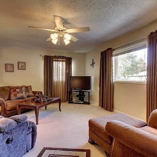 Cozy living room with comfortable seating, a television, and warm decor.