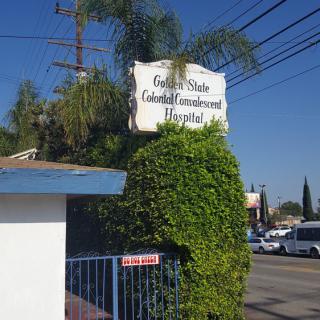 An outdoor sign for a medical center surrounded by greenery.