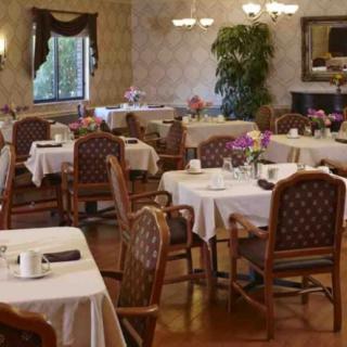 An elegantly decorated dining room with tables and chairs arranged neatly.