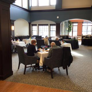 A cozy dining area with people enjoying a meal together.