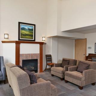 A modern living room with comfortable seating and a cozy fireplace.