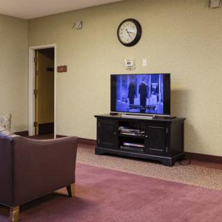 A cozy living room setup with a television and comfortable seating.