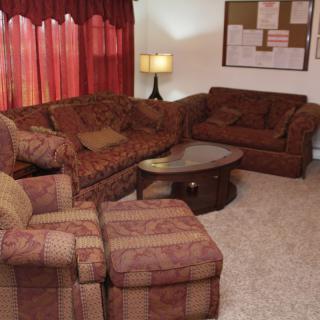 A cozy living room with comfortable seating and warm lighting.