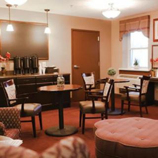A cozy waiting room with a coffee station and comfortable seating.