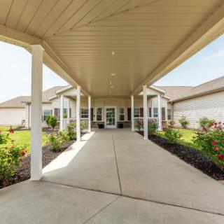 A welcoming entrance with a spacious walkway and well-maintained landscaping.