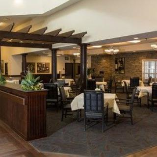 A spacious restaurant dining area with neatly arranged tables and chairs.