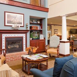 A cozy living room with a fireplace and comfortable seating.