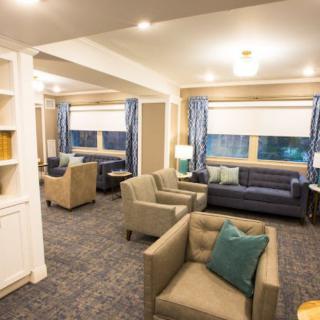 A cozy lounge area with sofas and armchairs in a modern interior setting.