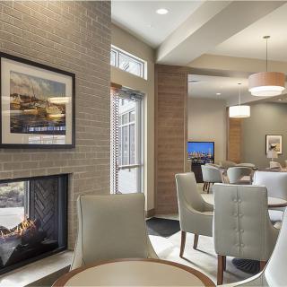A modern and cozy seating area with a fireplace and contemporary furniture.