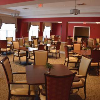 An empty dining room with neatly arranged tables and chairs.
