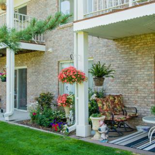 A cozy outdoor space with vibrant flowers and comfortable seating, perfect for relaxing.