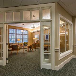 A cozy lobby area with seating and large windows.