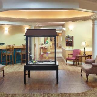 A well-lit lobby area with comfortable seating and a central display case.