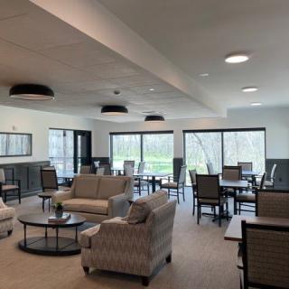 A spacious and modern lounge area with comfortable seating and large windows allowing for natural light.