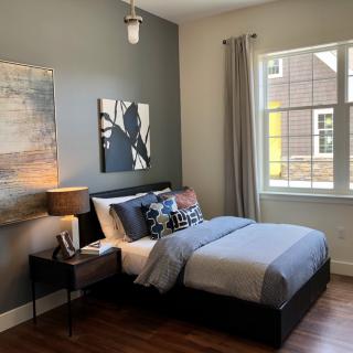 A modern bedroom interior with stylish decor and a neatly made bed.
