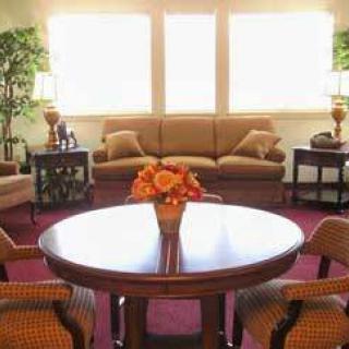 A cozy living room with a central table and comfortable seating.