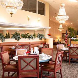 An elegant dining area featuring stylish chandeliers and neatly arranged tables.