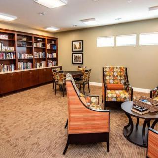 A cozy library with comfortable seating and well-organized bookshelves.