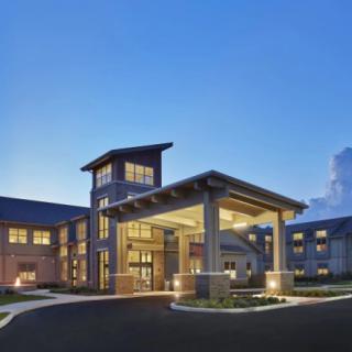 A well-lit building entrance during the evening.