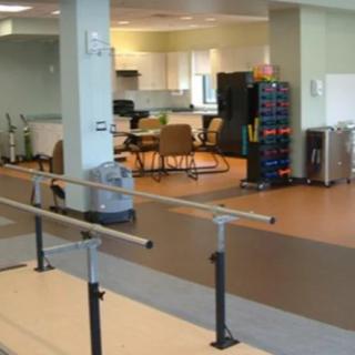 A rehabilitation center therapy room equipped with exercise and physical therapy equipment.