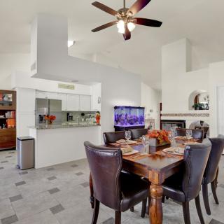 A modern dining room with an open layout and stylish furnishings.