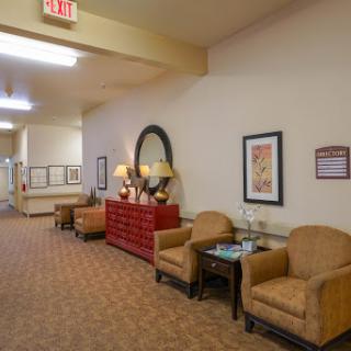 A cozy hallway featuring comfortable seating and decorative elements.