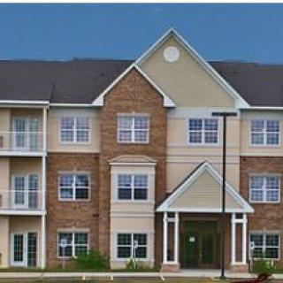 A multi-story residential apartment building with a brick facade.