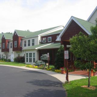 A beautiful residential building with a green roof and landscaped surroundings.