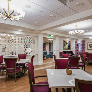A modern dining area with elegantly arranged tables and chairs.