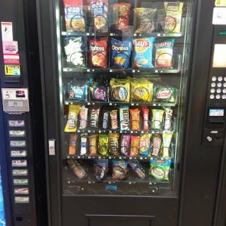A vending machine filled with a variety of snacks and drinks.