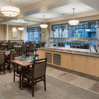 An elegant indoor dining area with neatly arranged tables and a buffet counter.